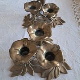 An antique pair of candlesticks with a floral design.