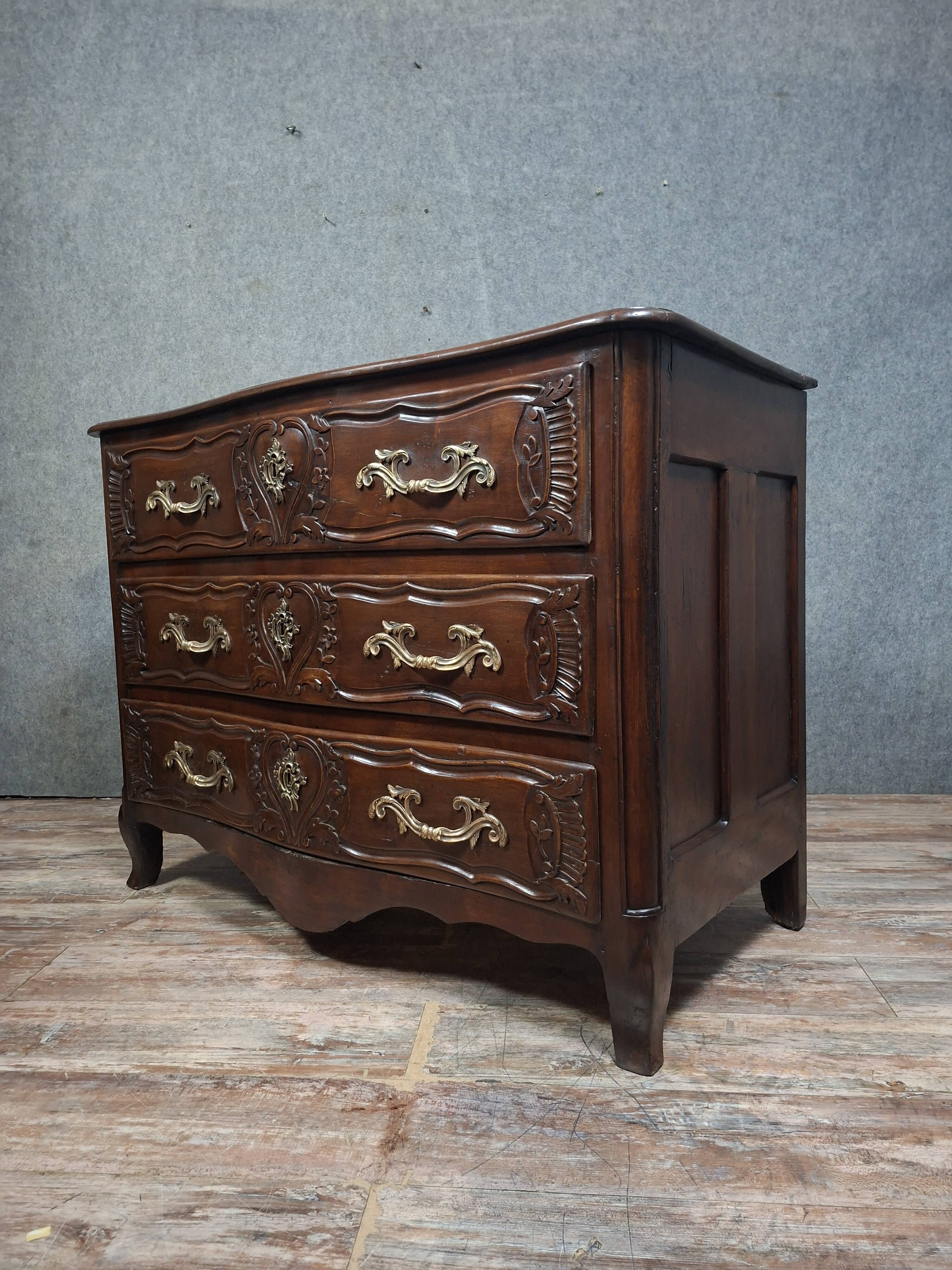 Louis XV/XVIII period Lyonnaise commode in moulded and carved walnut.