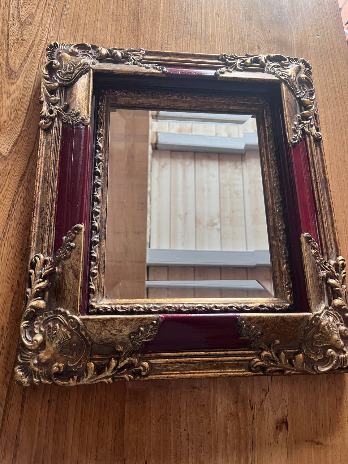 Old mirror with gold and red frame
