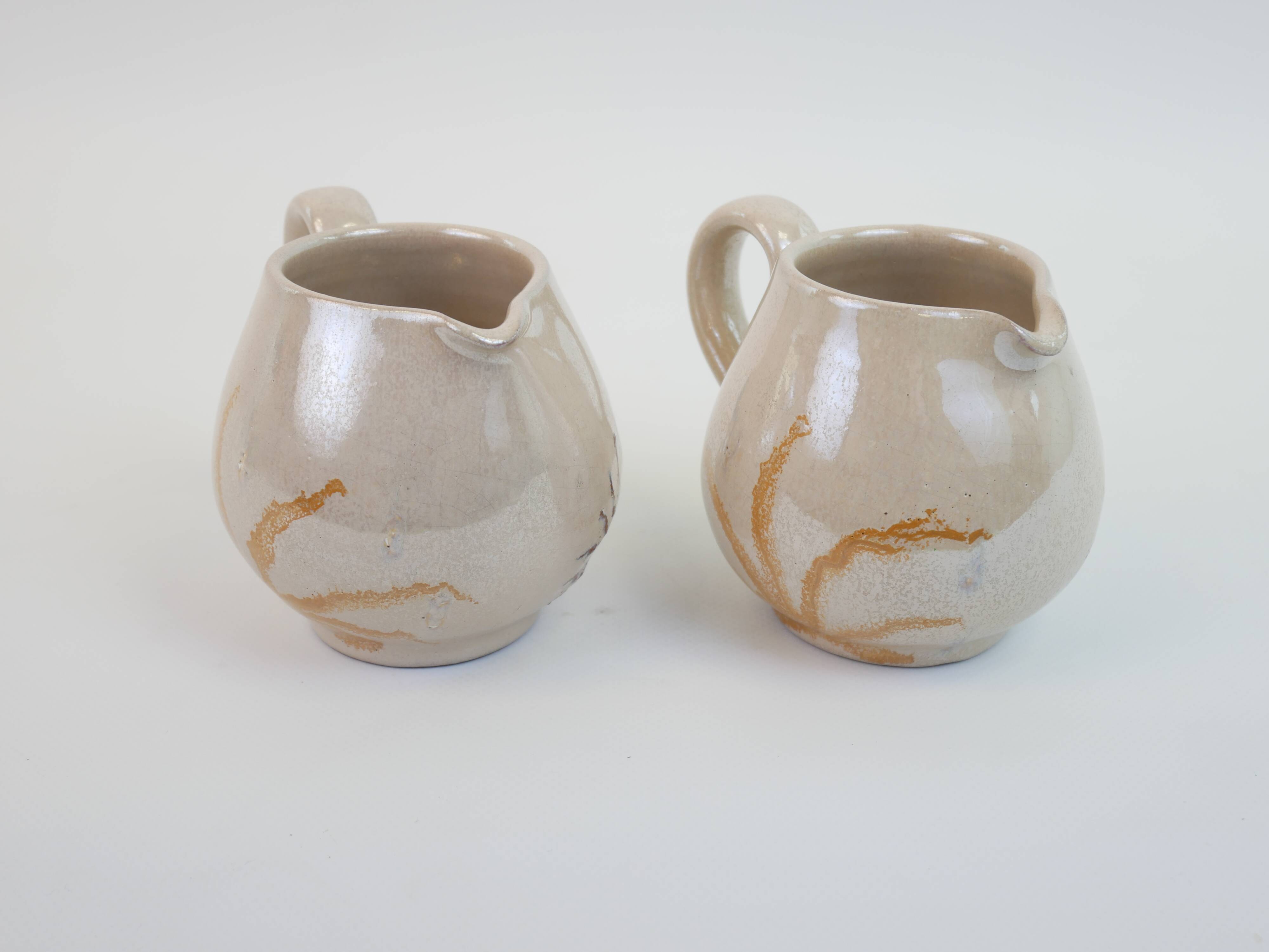 Pair of ceramic milk jugs signed La Roue Vallauris