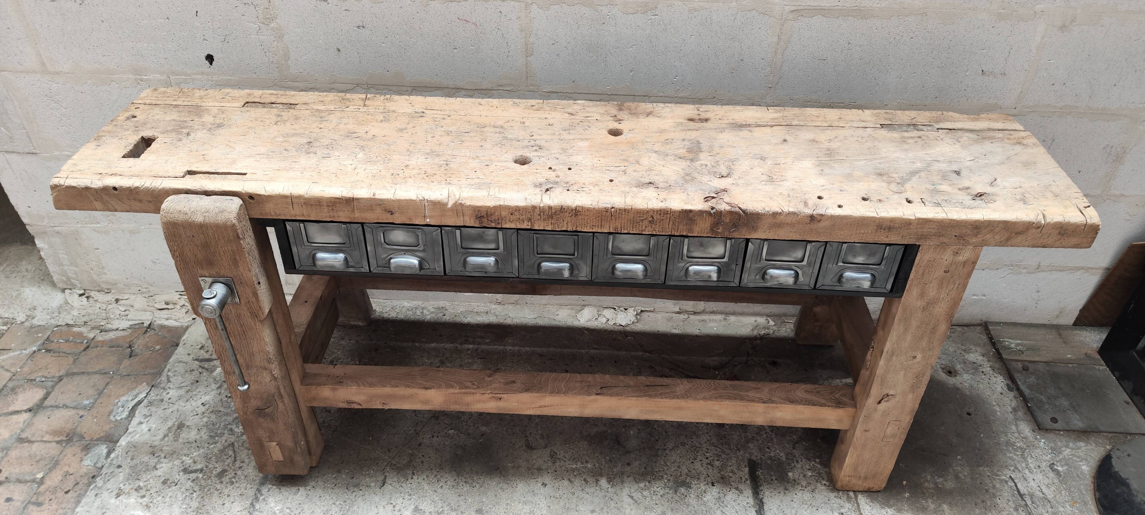 Old carpenter's workbench with eight metal drawers, industrial console