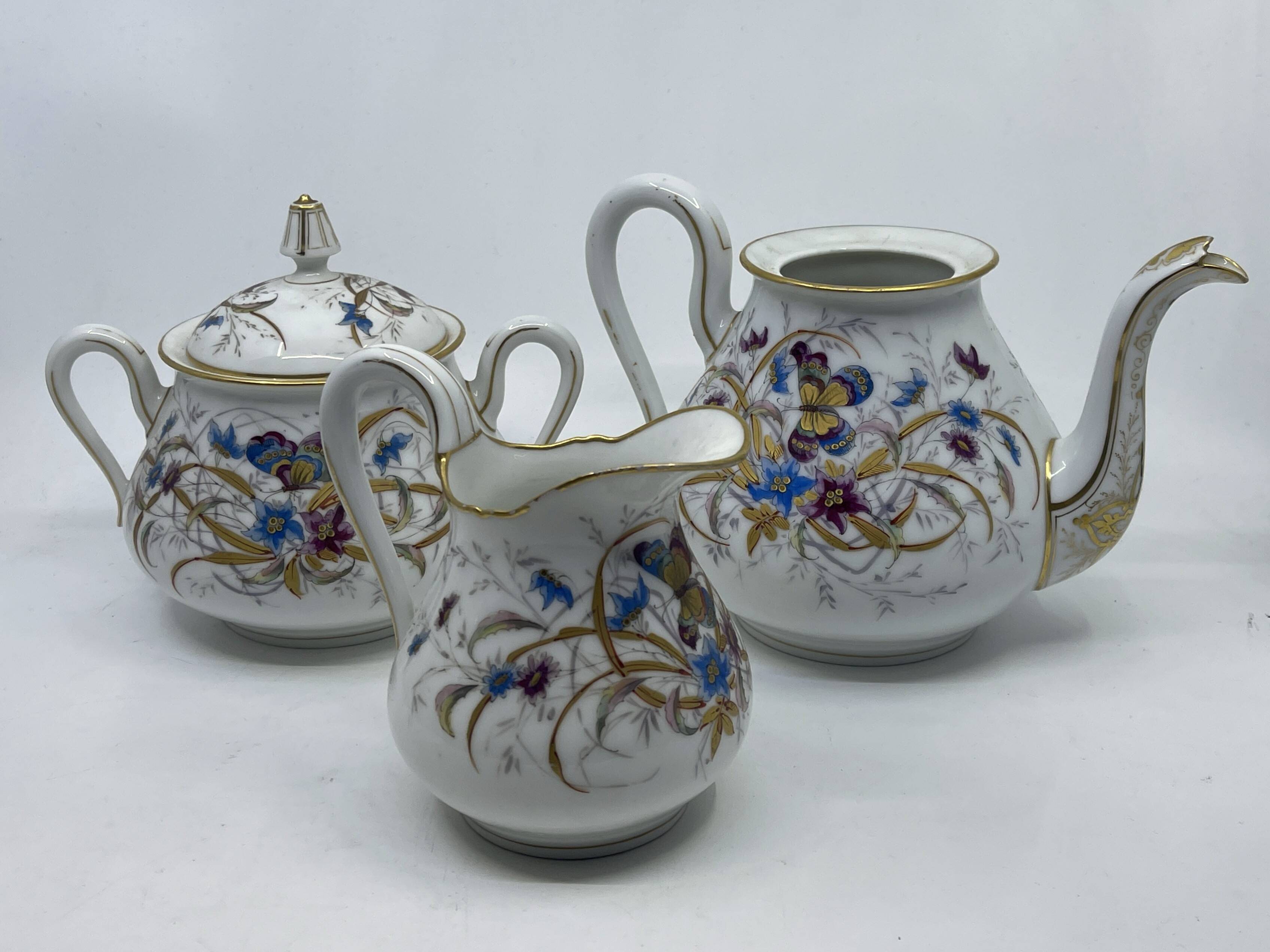 Porcelain tea service with floral and butterfly decorations, 25 pieces.