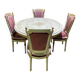 Louis XVI dining room table set with painted wood, gold accents, and pink velvet.