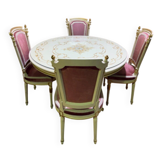Louis XVI dining room table set with painted wood, gold accents, and pink velvet.