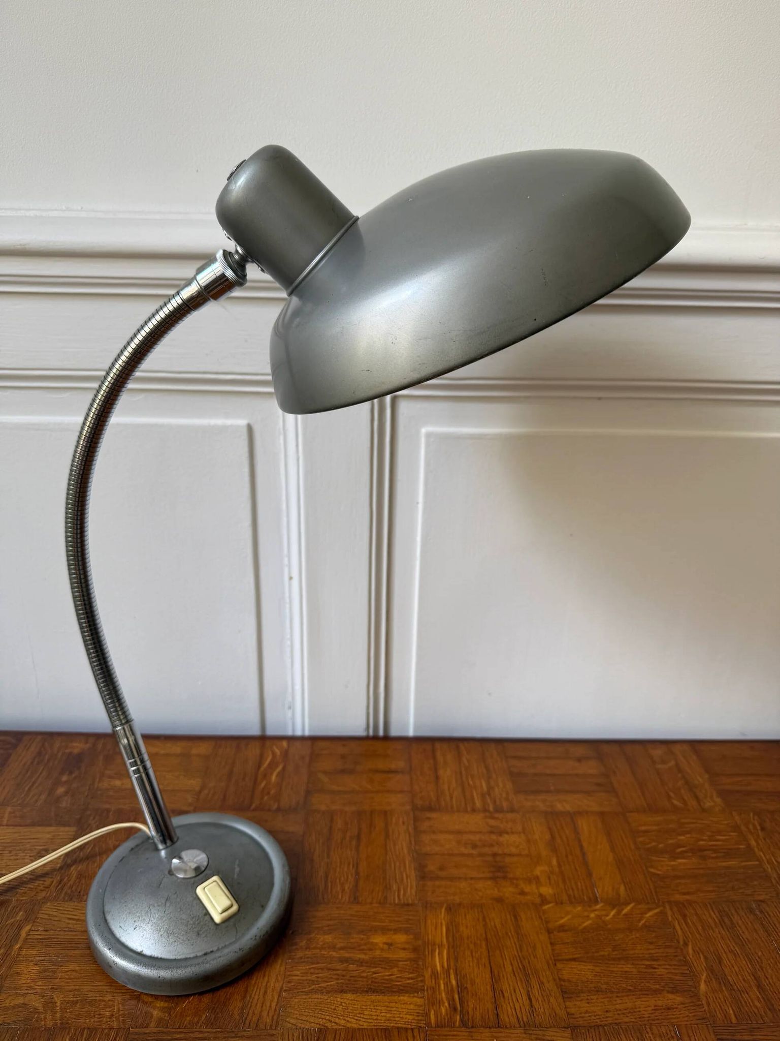 Industrial metal workshop lamp with a gooseneck.