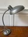 Industrial metal workshop lamp with a gooseneck.