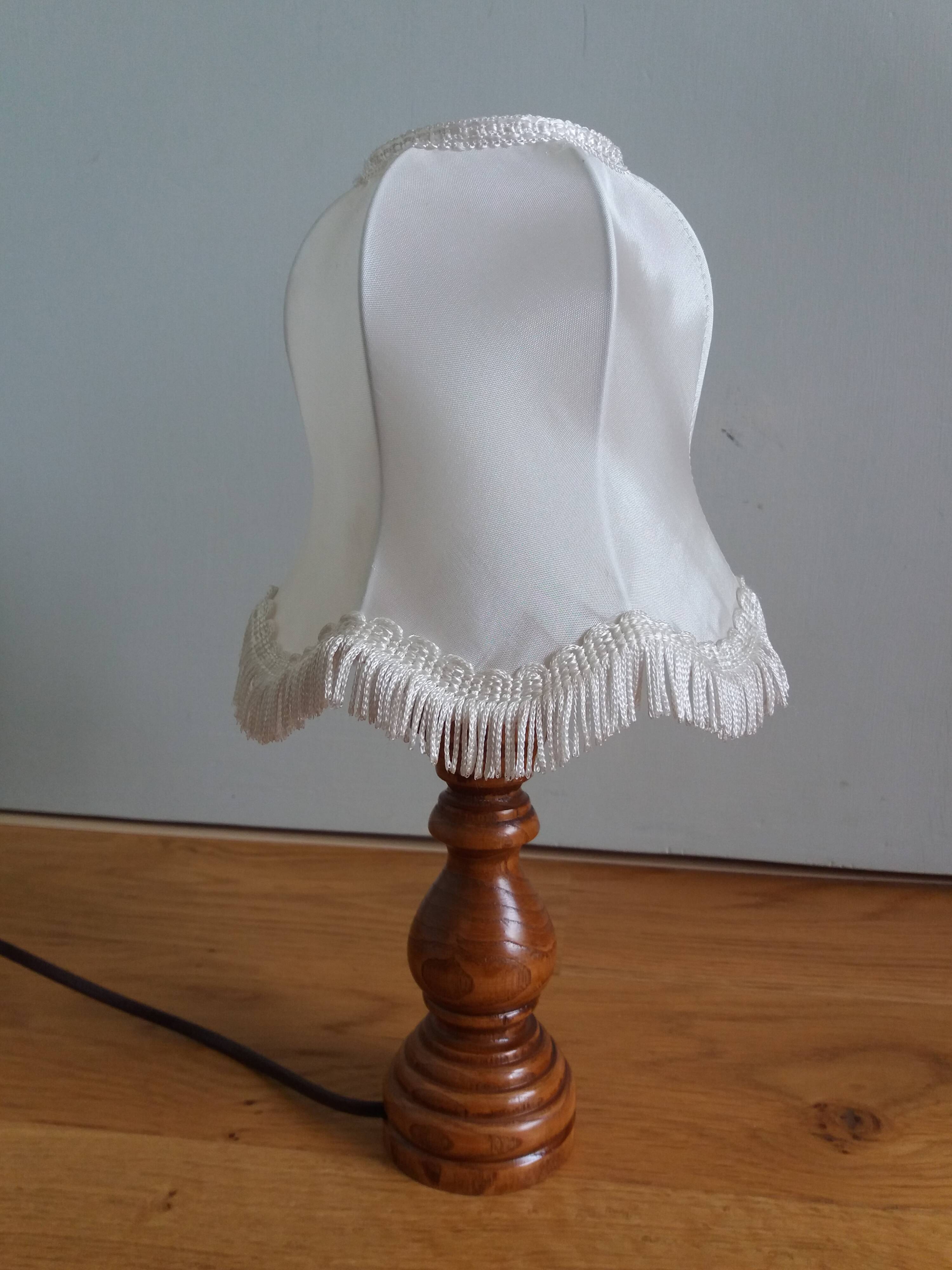 Turned wood lamp with fabric lampshade