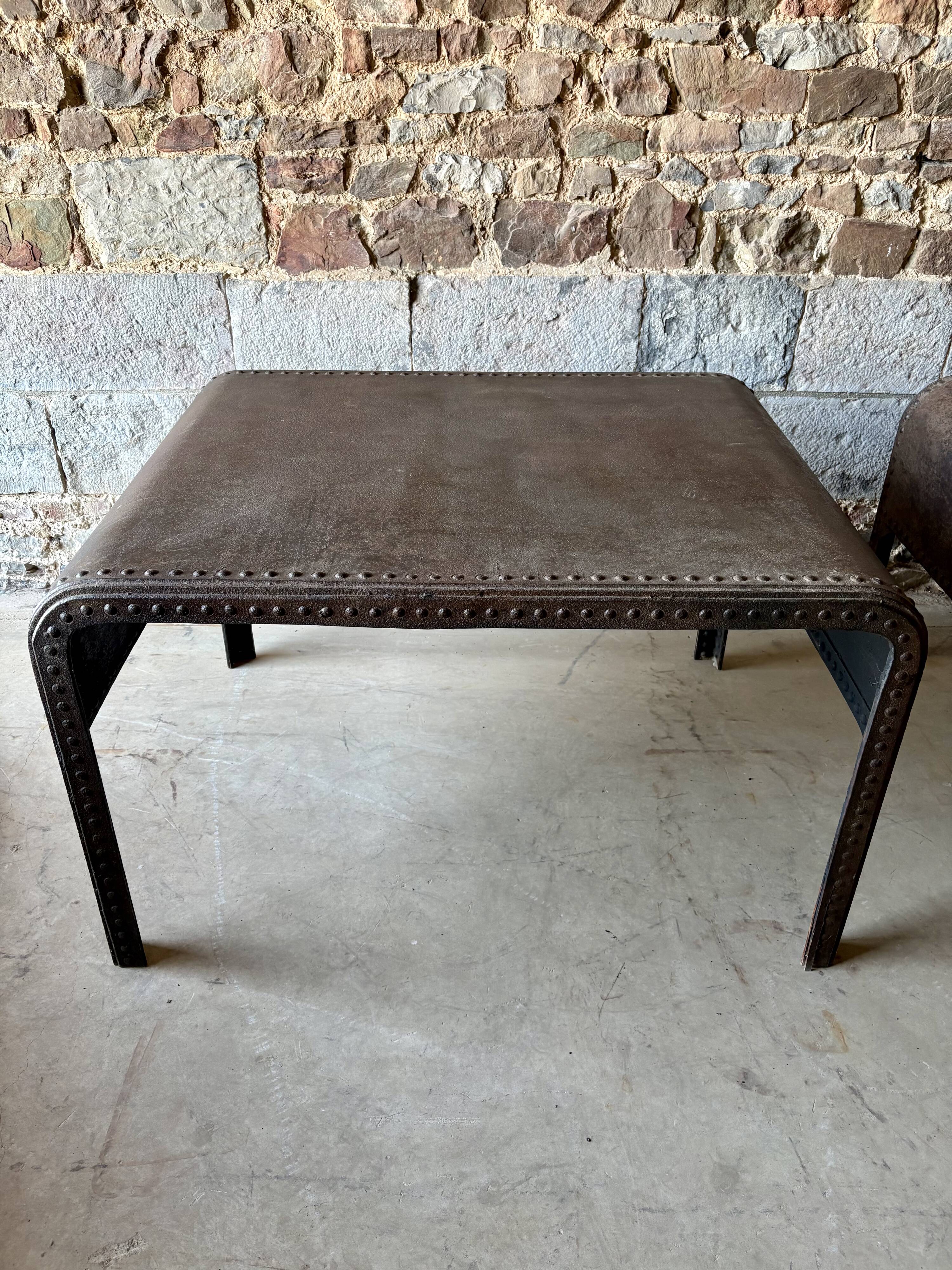 Pair of large riveted metal industrial tables