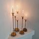 Gunnar Ander, four candlesticks, brass and glass, Ystad Metall, Swedish modern.