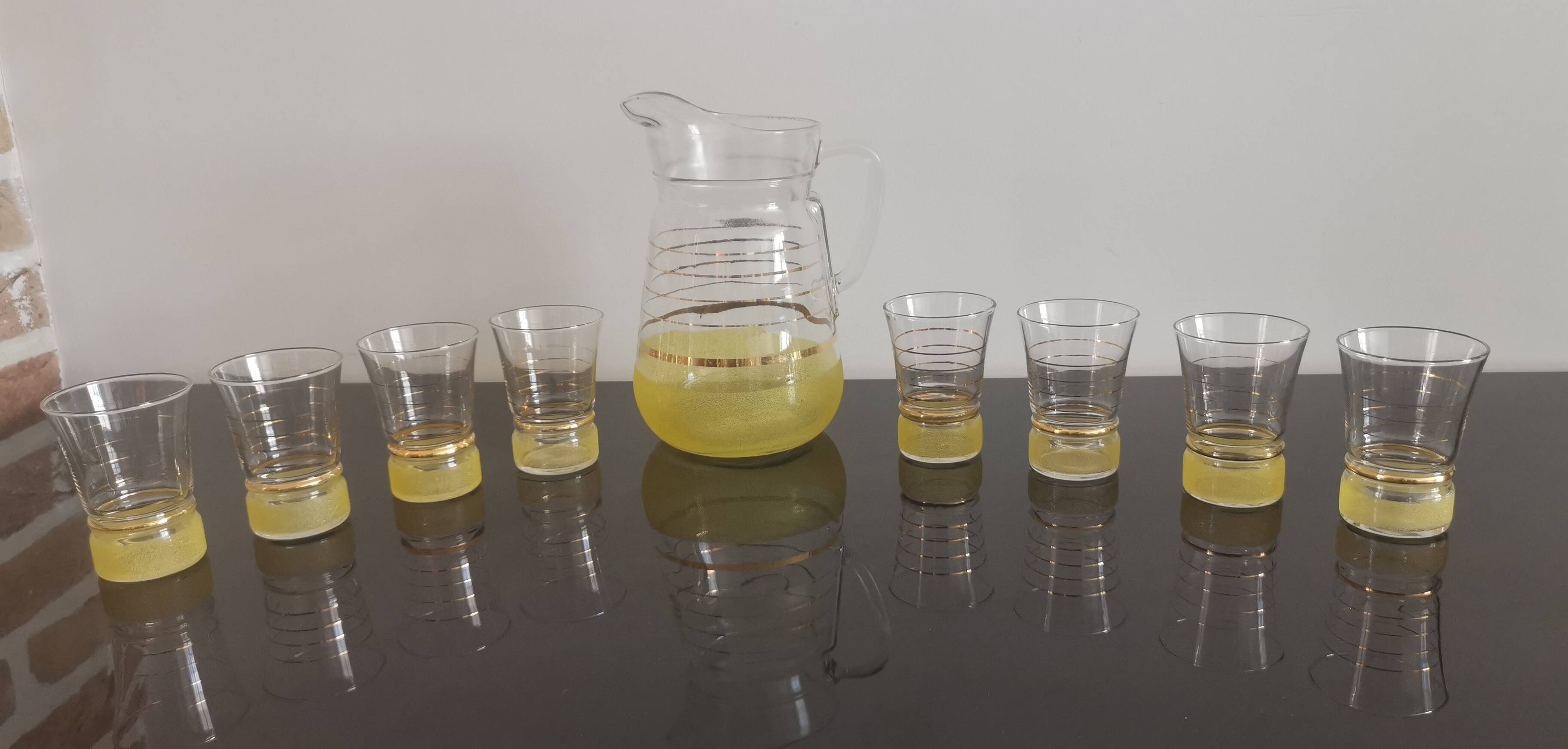 Old pitcher with its 8 yellow granite glasses with gold edging vintage 50's