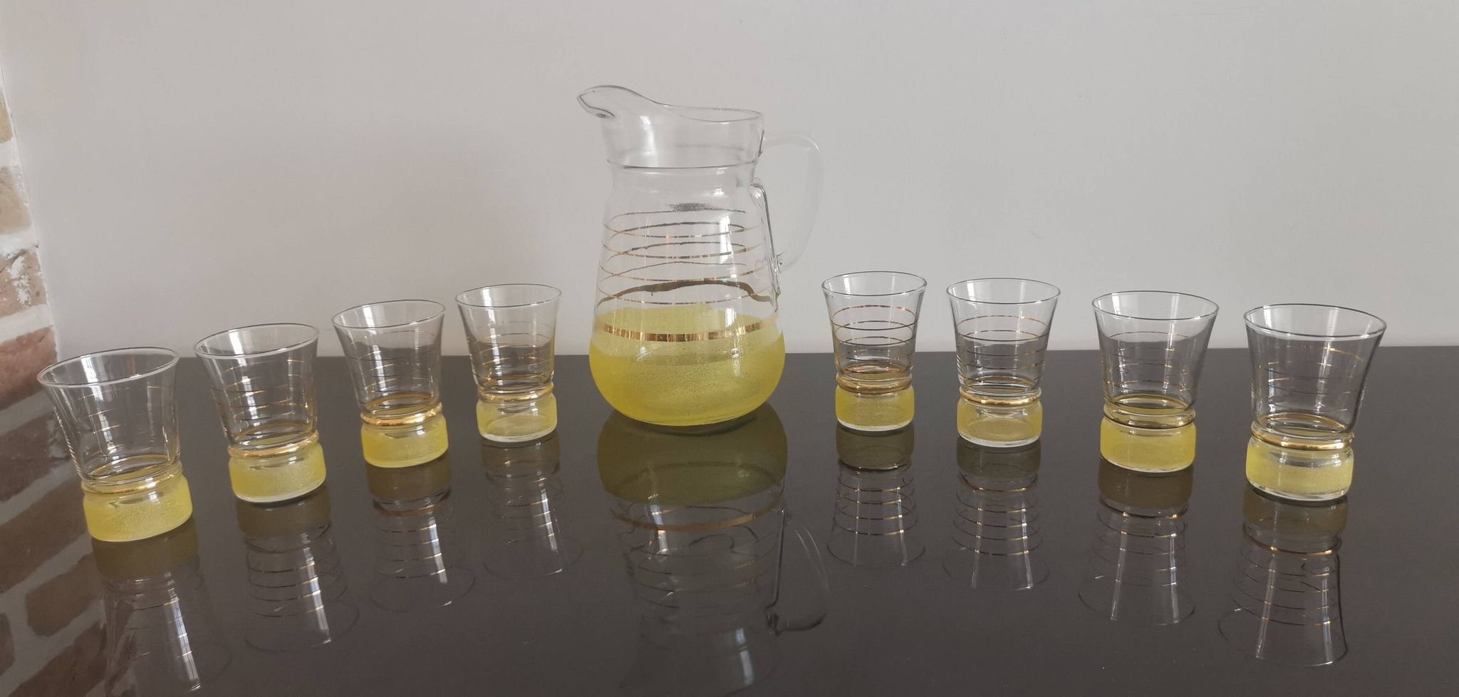 Old pitcher with its 8 yellow granite glasses with gold edging vintage 50's