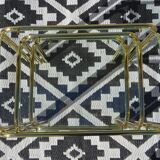 Nesting tables in gold-tone metal and glass
