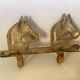 Wall-mounted coat rack with horses in brass