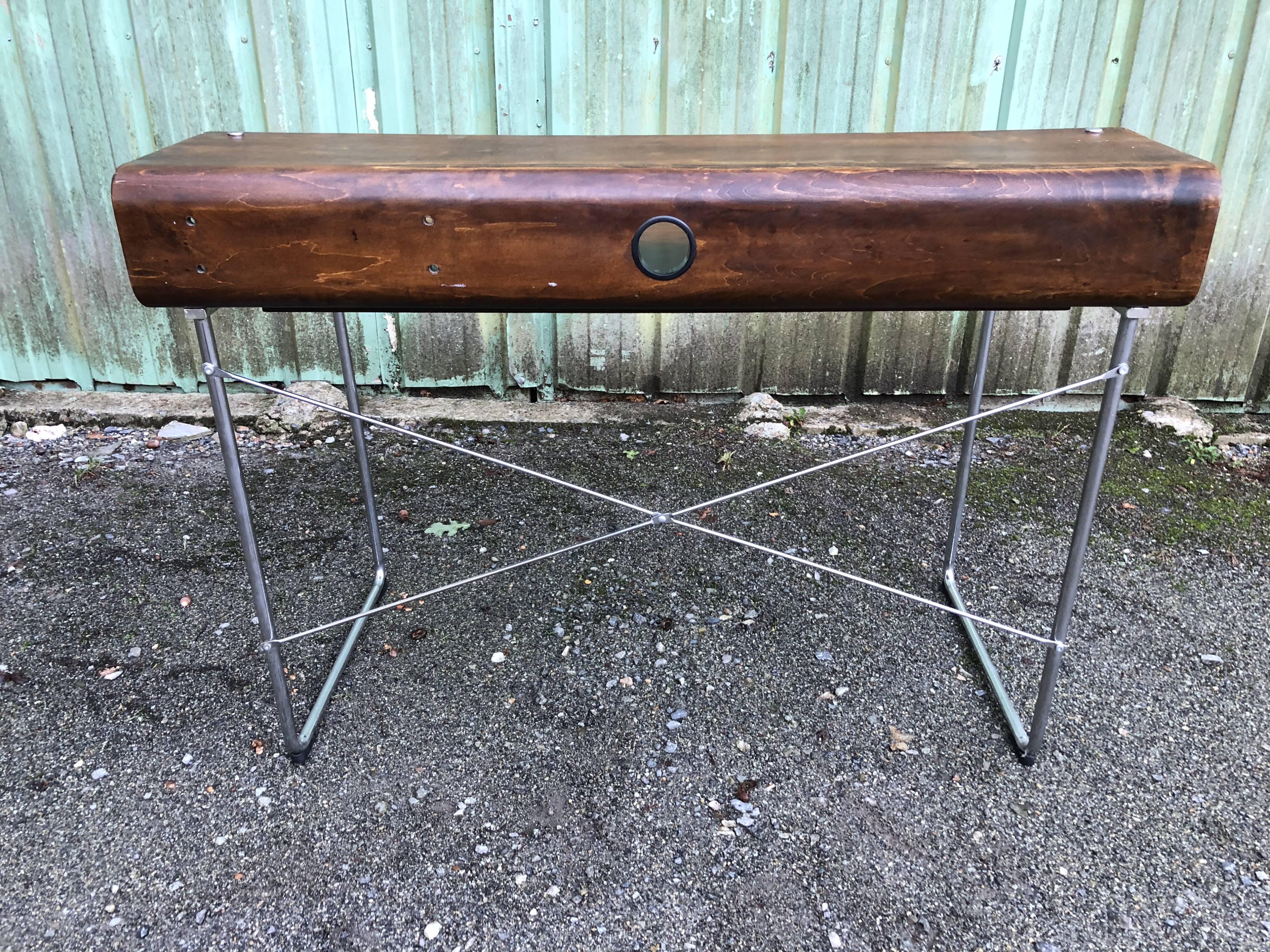 Design desk in formed glued laminated wood with chrome tubular base.