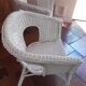 2 white wicker armchairs