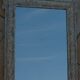 Chic and stylish old mirror with carved wooden frame in limed white and gold
