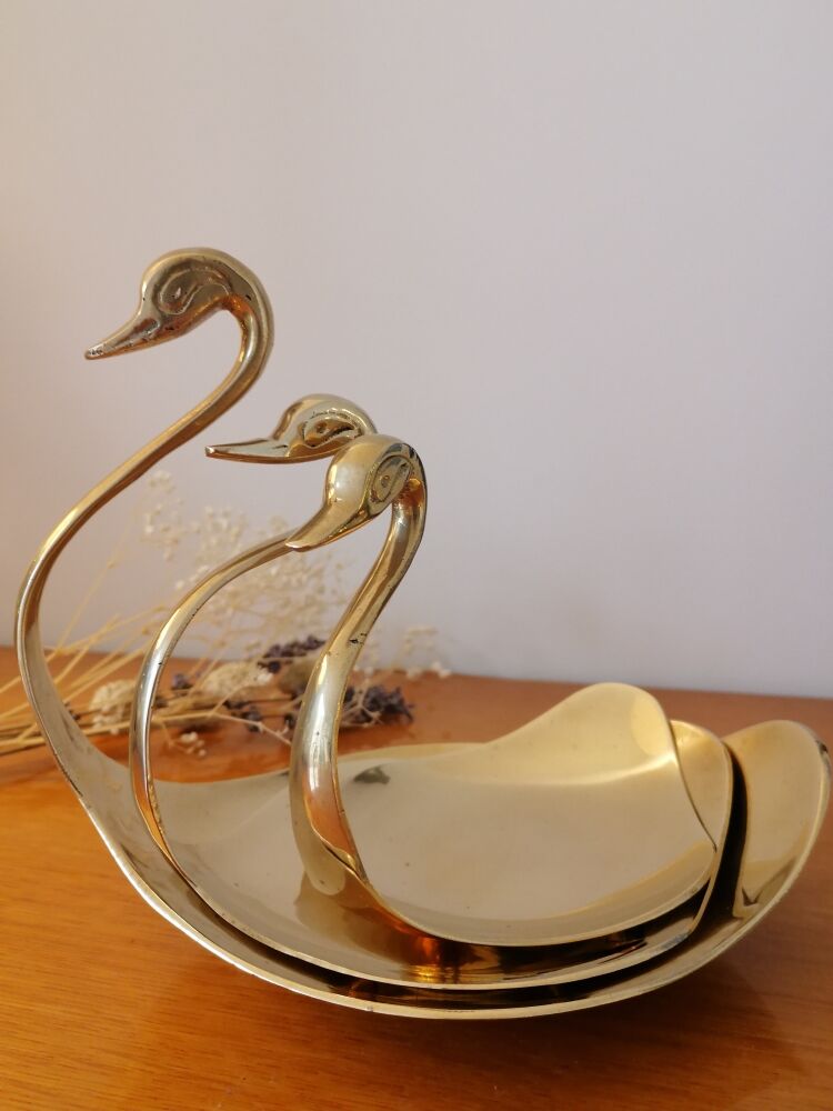 Empty brass swan pocket