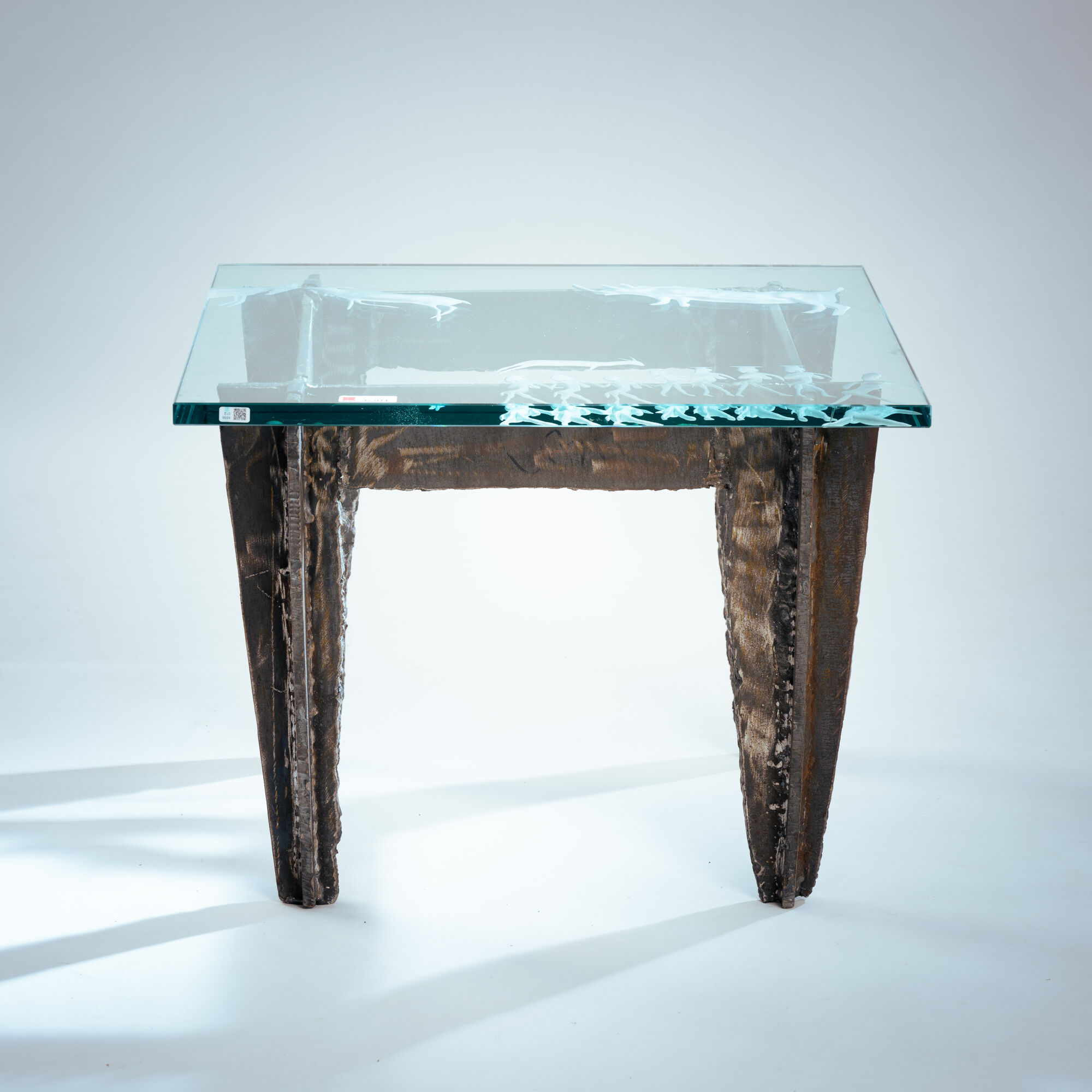 2 brutalist steel side tables with primitive  scene motifs etched glass