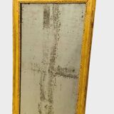 Louis XVI mirror in carved and gilded wood with leaf 18th century