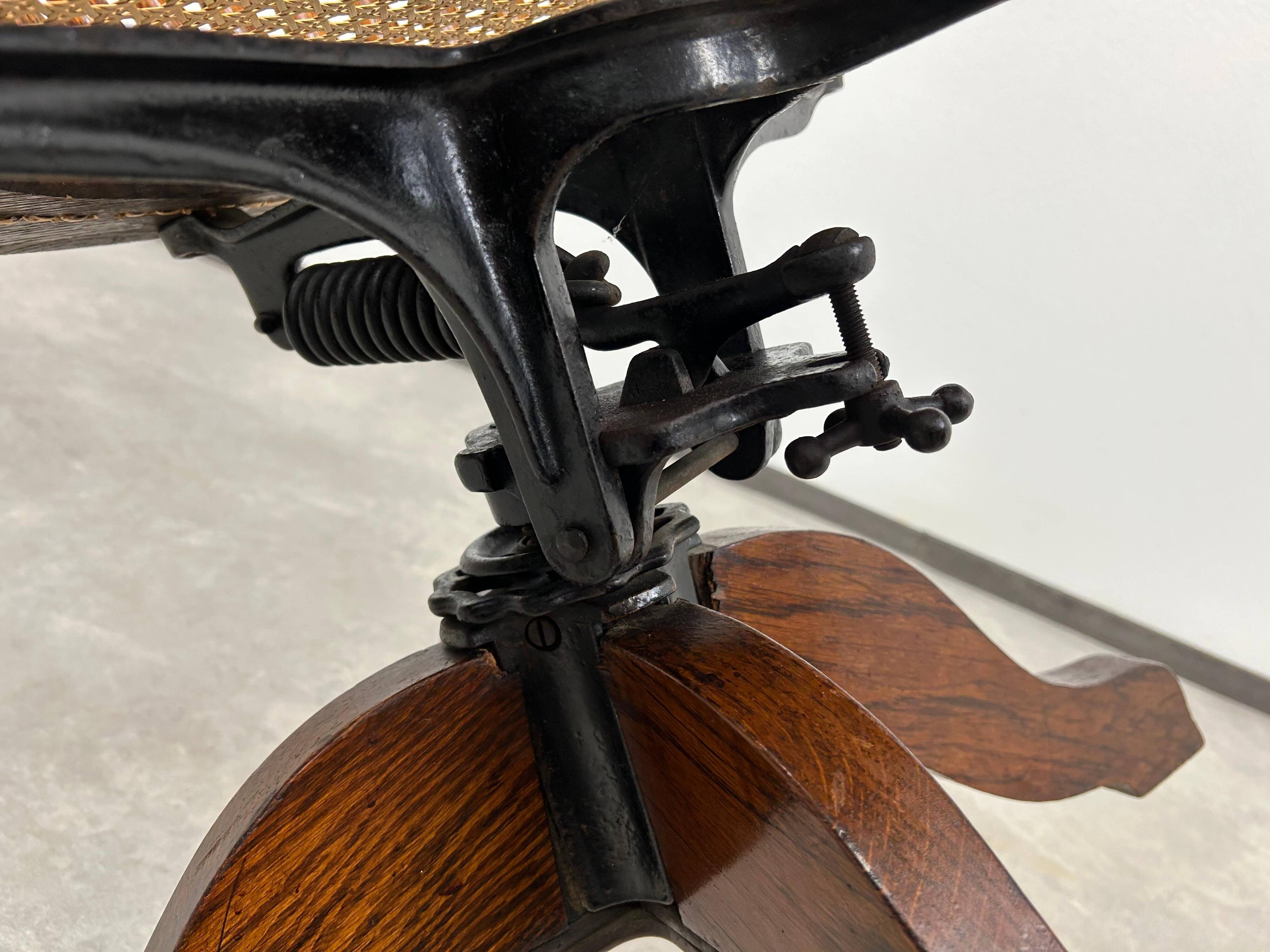 Swivel office chair in oak with a rattan seat.