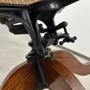 Swivel office chair in oak with a rattan seat.