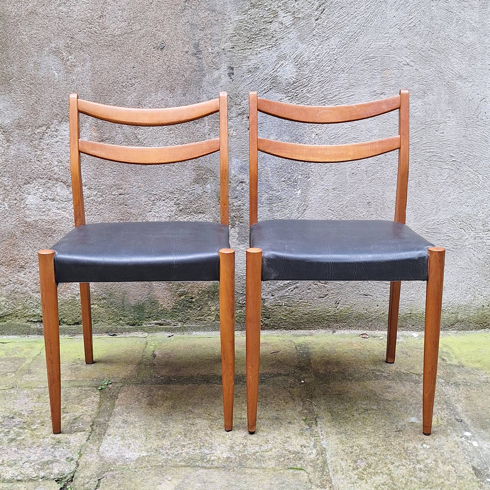 Pair of Scandinavian style chairs in wood and faux leather.