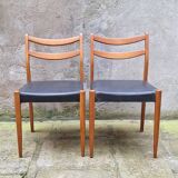 Pair of Scandinavian style chairs in wood and faux leather.