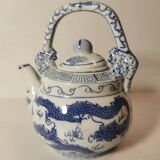 Old Chinese blue and white teapot in vintage ceramic with dragon decor