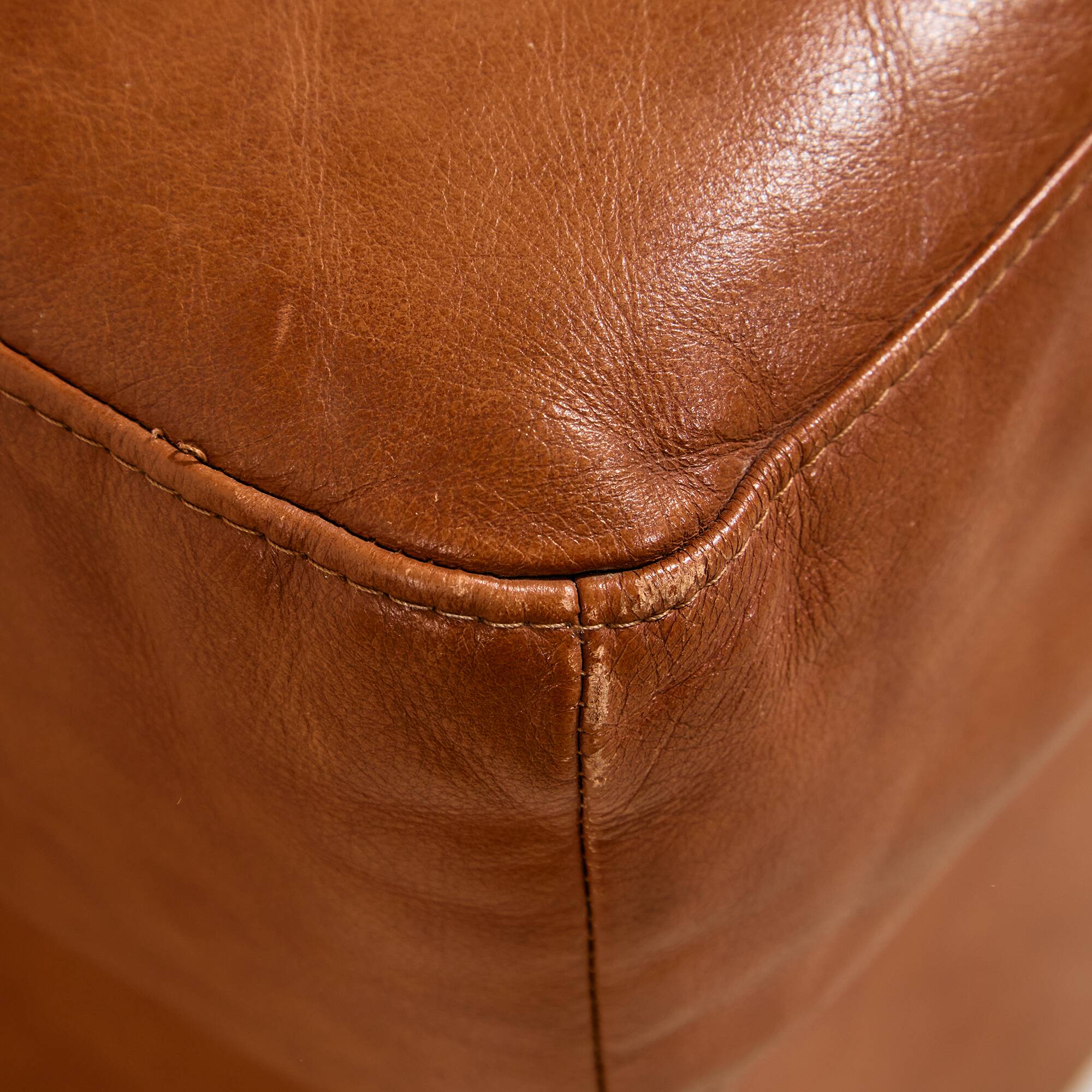 Ottoman with leather upholstery