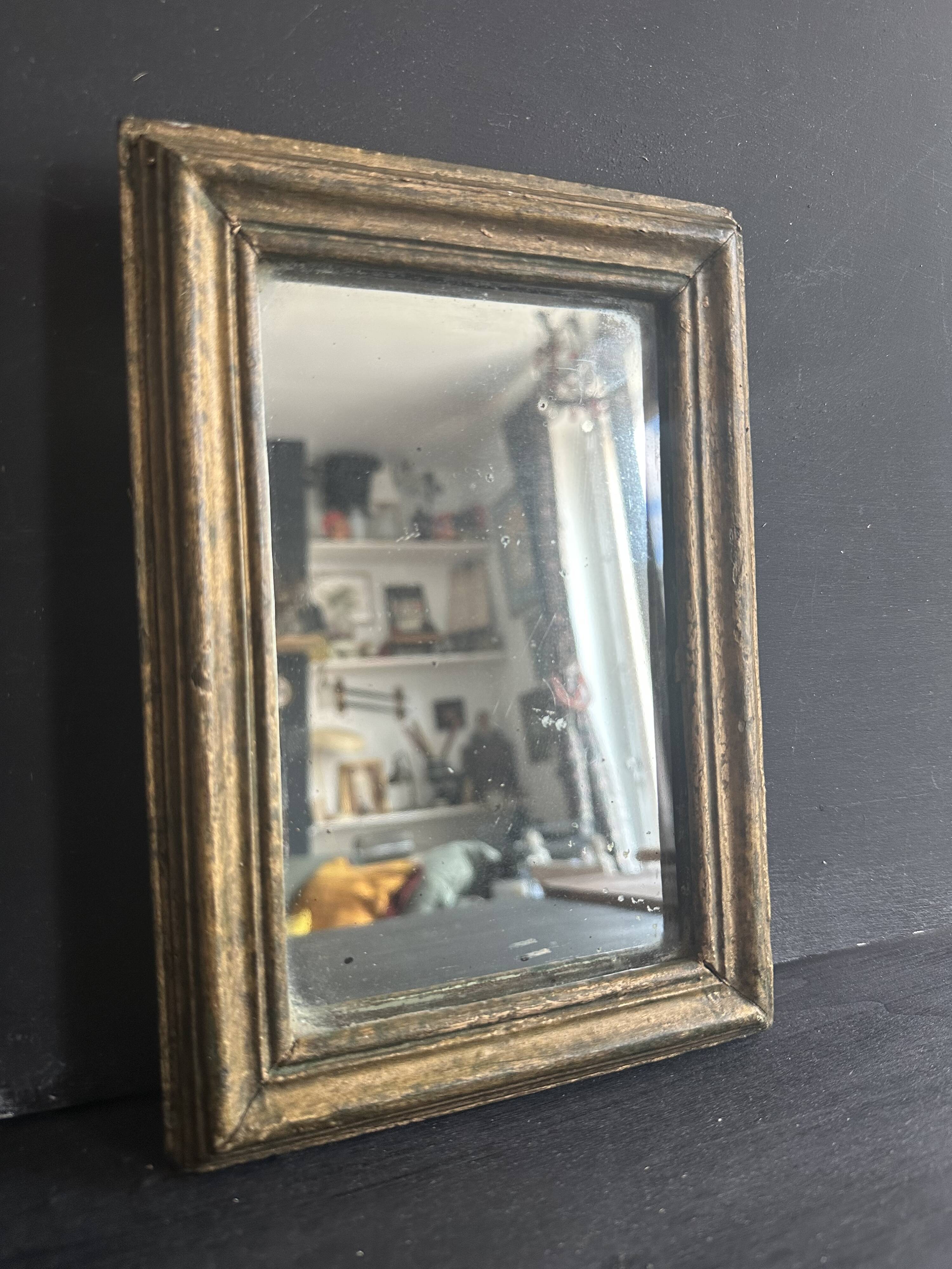 Miniature mirror from the 18th century in gilded wood, mercury glass.