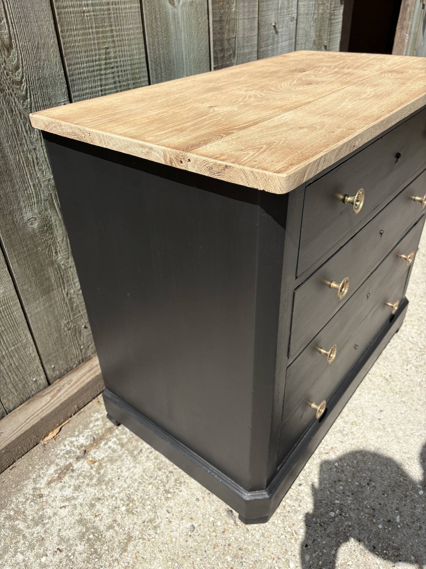 Antique commode with a matte black finish.