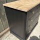 Antique commode with a matte black finish.