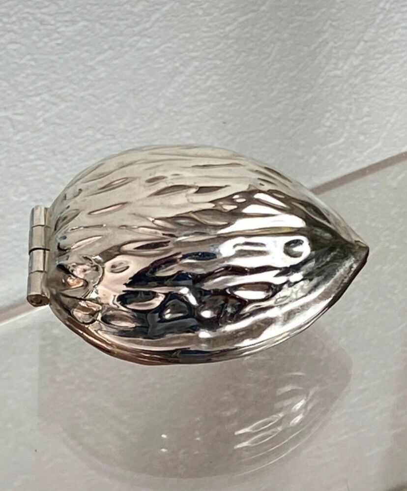 Nutcracker in the shape of a nut in silver-plated metal.