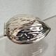 Nutcracker in the shape of a nut in silver-plated metal.