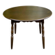 Extendable round table in solid wood with a dark oak satin finish.