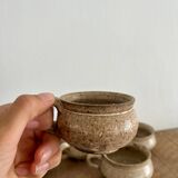 4 stoneware coffee cups and saucers