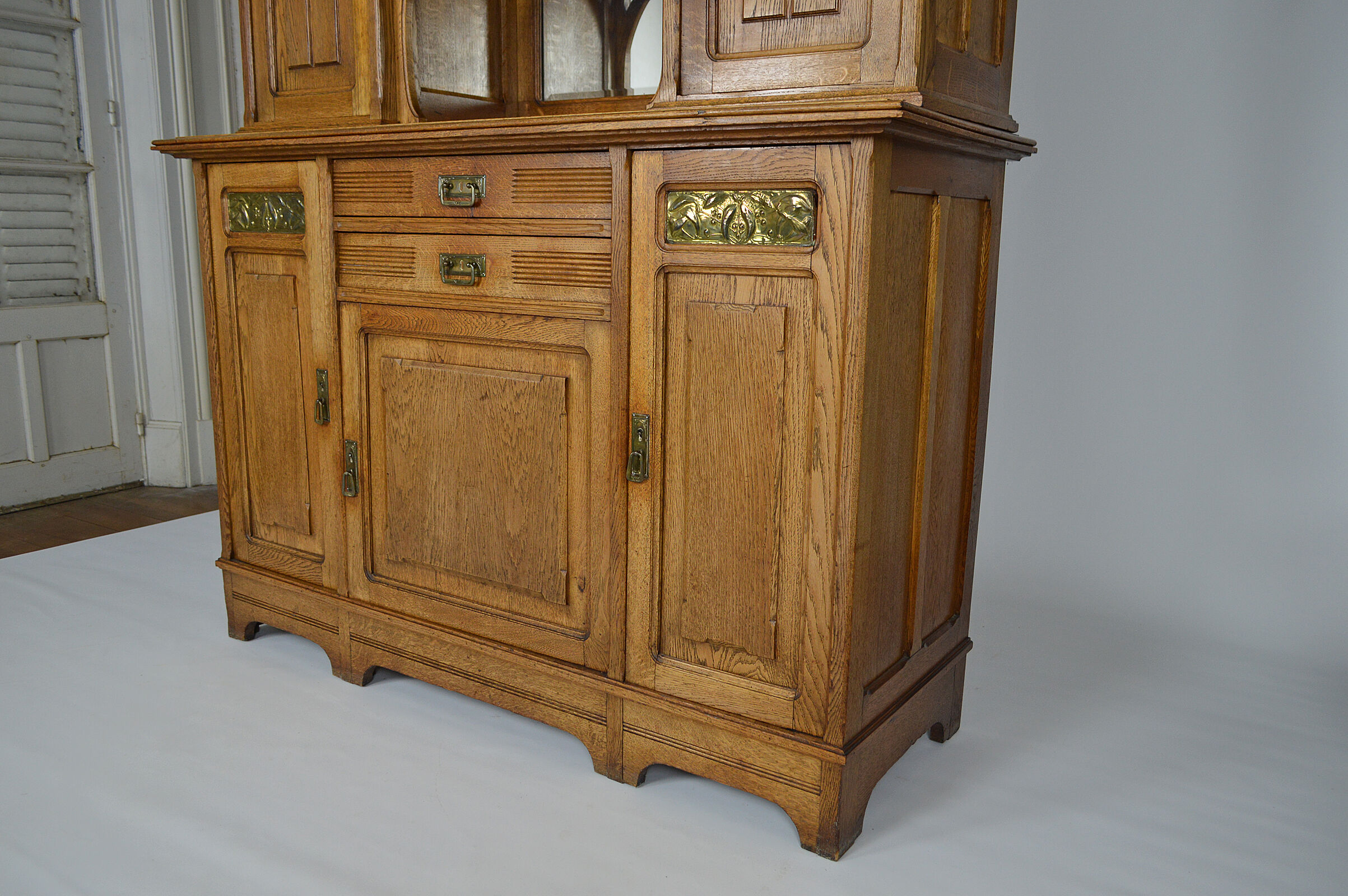 Art Nouveau oak buffet and dinanderie panels, circa 1910