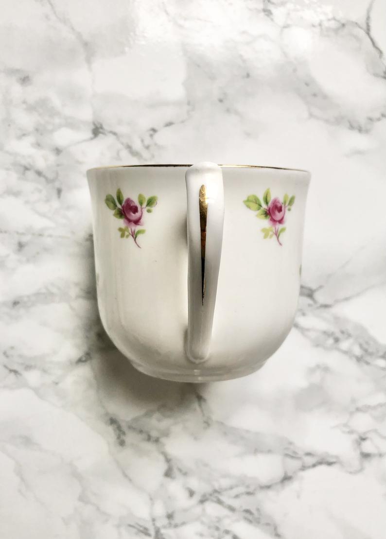 Teacup on its saucer and porcelain cake plate