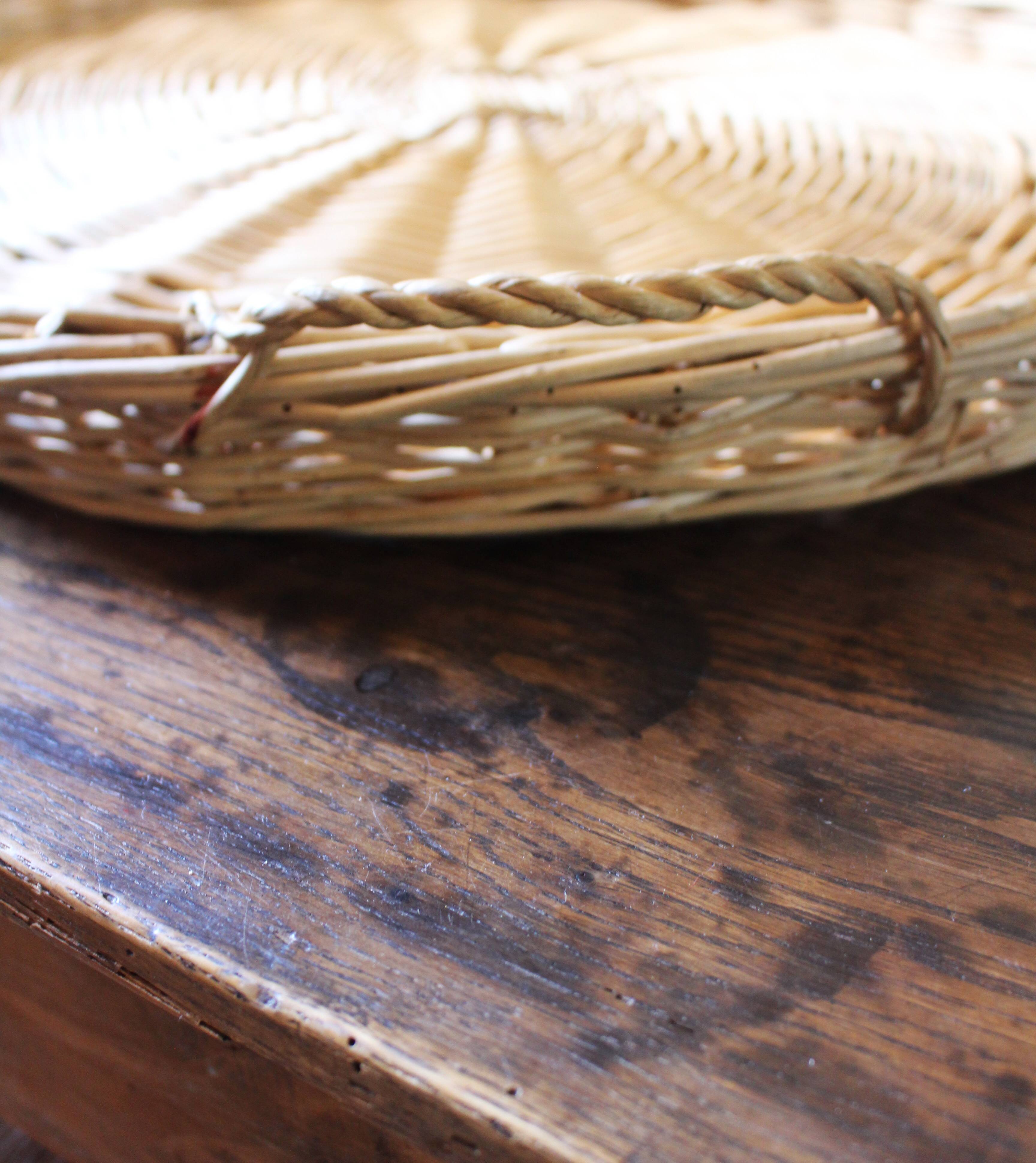 Large round wicker tray with two handles, vintage weaving.