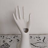 Hand holds white jewelry, ring sizer
