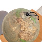 Old illuminated globe world map made of glass and paper.