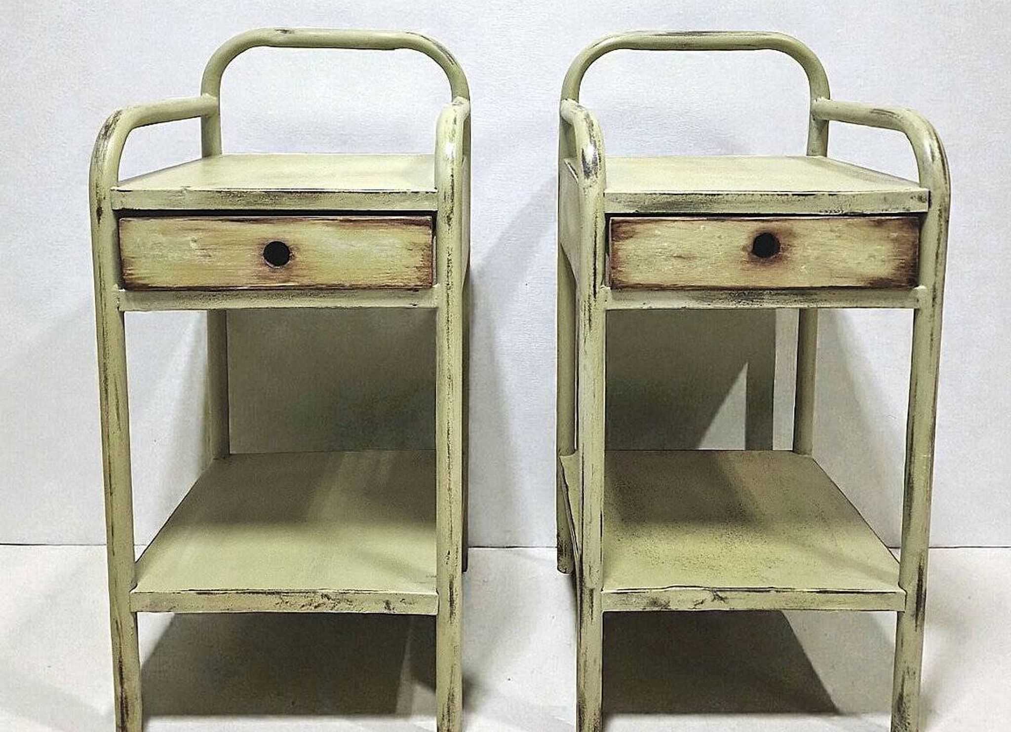 Copy of a pair of patinated metal bedside tables.