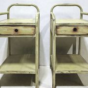 Copy of a pair of patinated metal bedside tables.