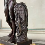 Dionysus on the shoulders of a satyr, bronze after the antique on a yellow Siena base.