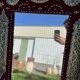 Large oriental mirror with embossed brass decoration on a red velvet background