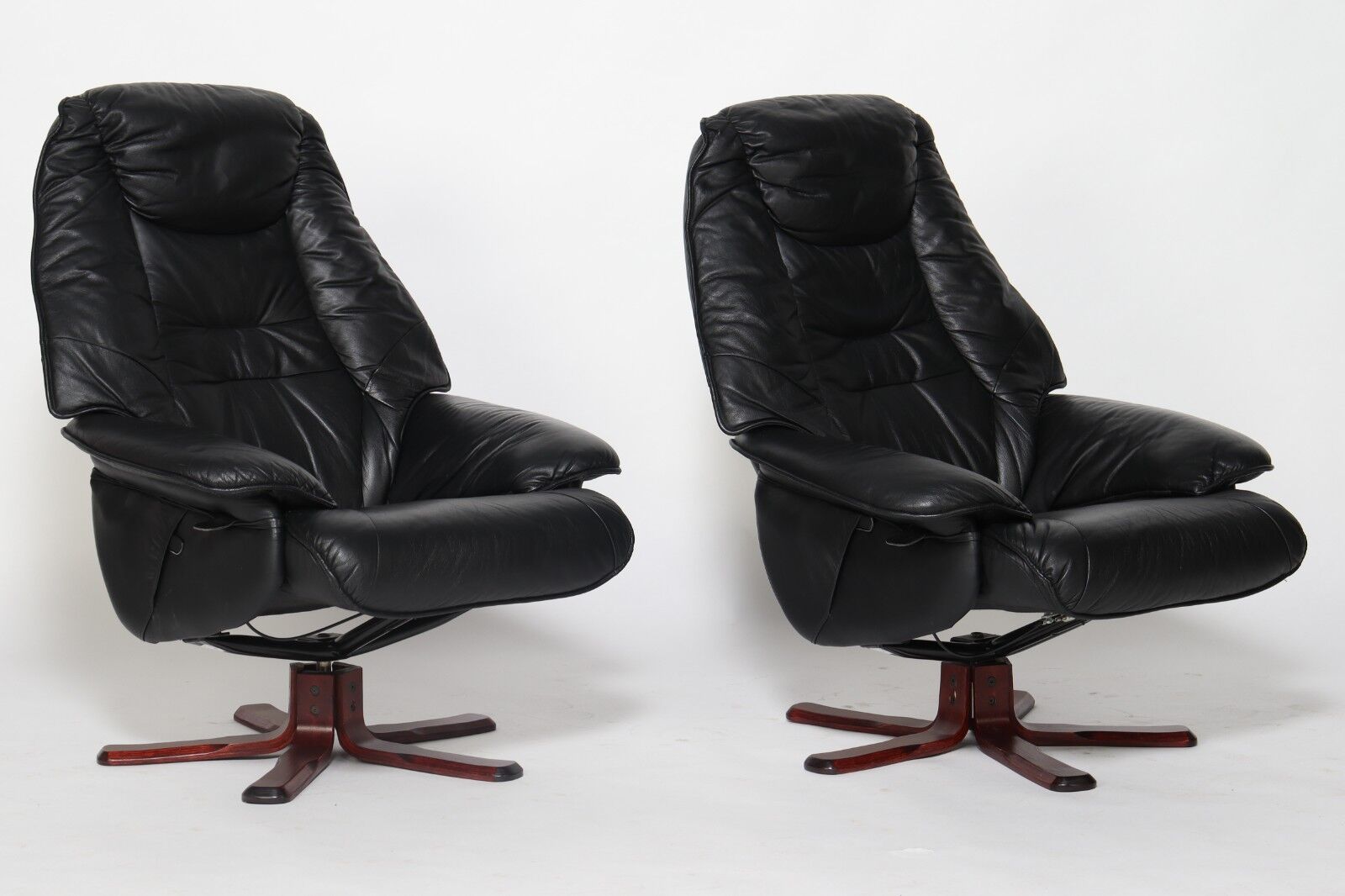 Pair of Danish black leather recliner swivel chairs by Hjort Knudsen