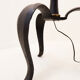 Tripod floor lamp in wrought iron and brass with bamboo-style base.