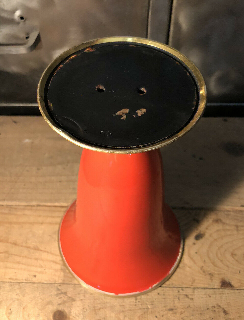 Cut vase on foot in red and black metal