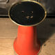 Cut vase on foot in red and black metal
