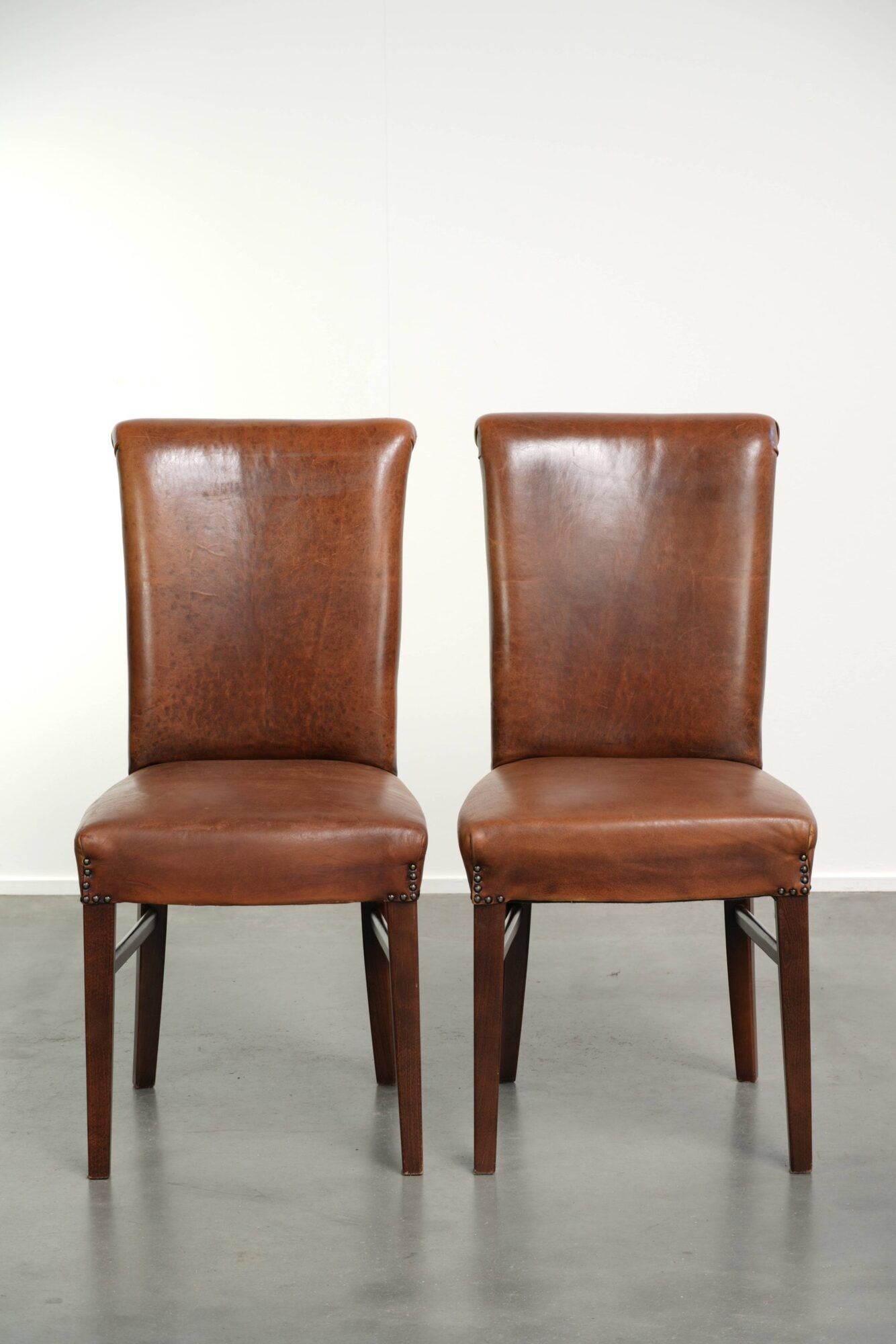 Set of 6 sheepskin dining chairs in a cognac colour with a lovely patina